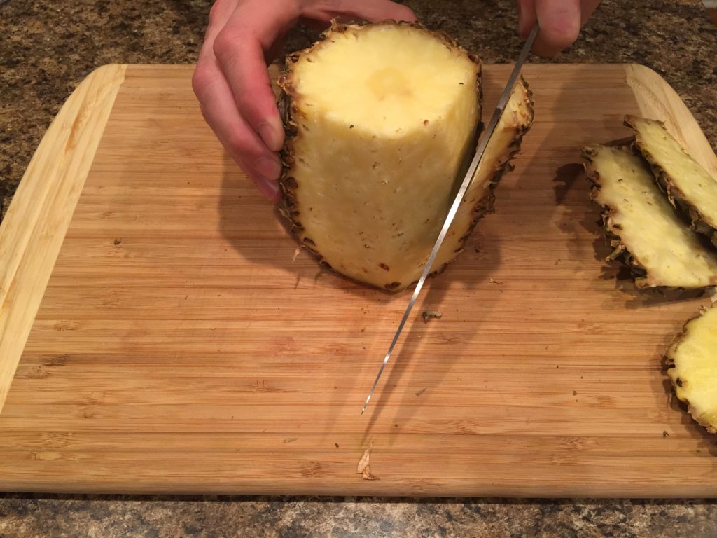Cut pineapple down the side