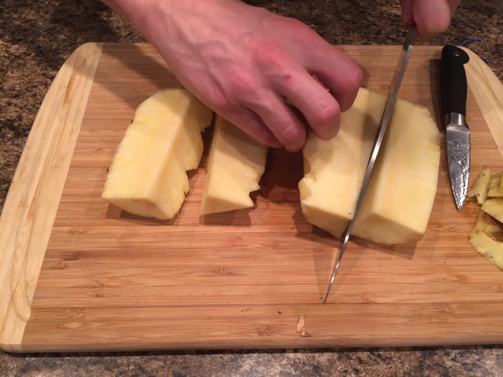 Cut pineapple into quarters