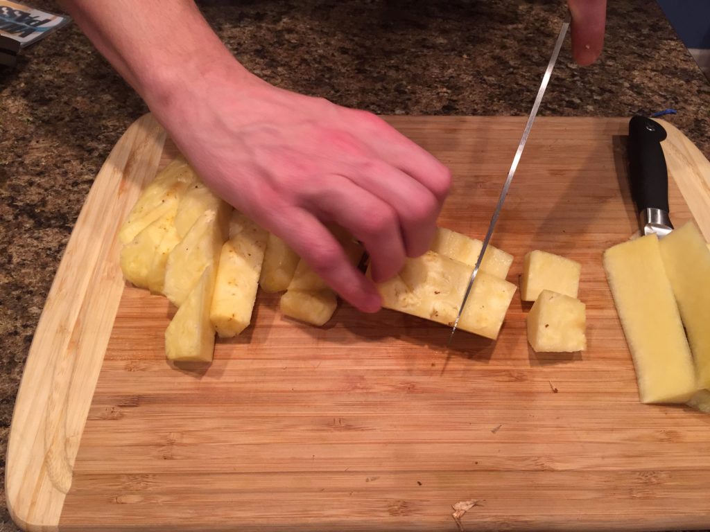 Cut pineapple down the side
