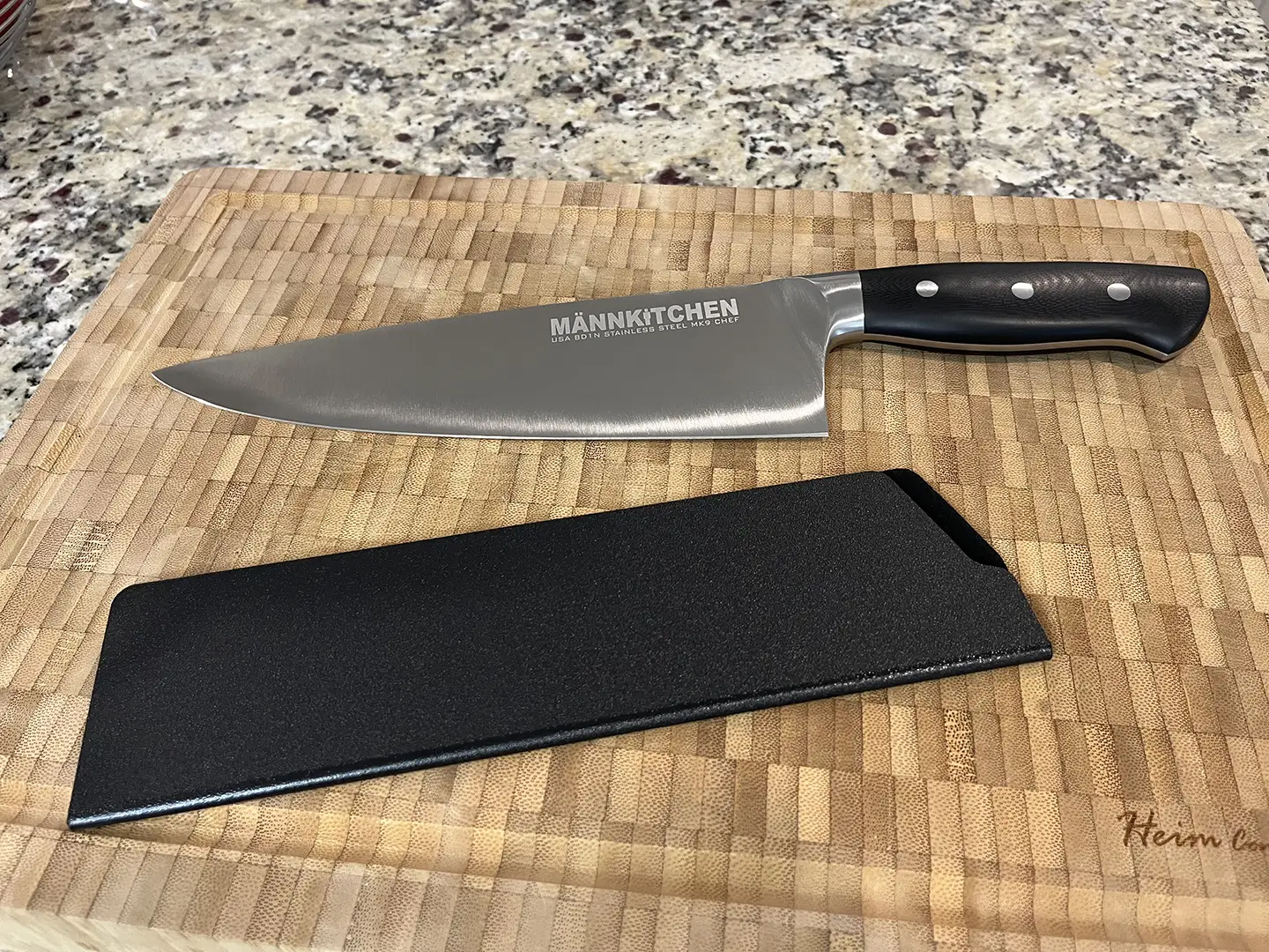https://steelbluekitchen.com/wp-content/uploads/2023/01/Mannkitchen-MK9-Chef-Knife-Sheath.webp
